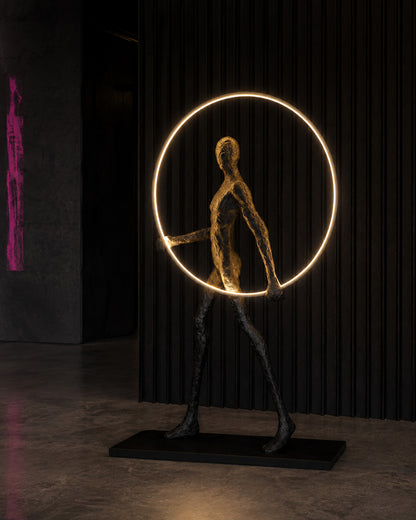 ORBIT WALKER — Drop 028 sculptural halo floor light in a dark gallery